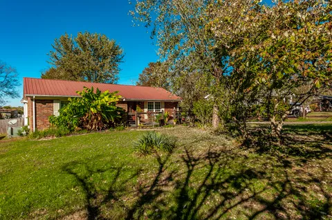 a view of patio with table and chairs under an umbrella