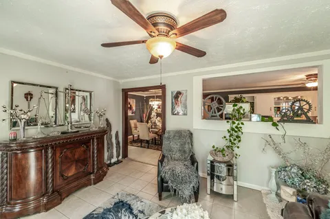 a living room with furniture and a chandelier