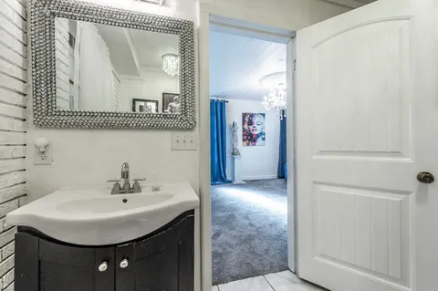 a bathroom with a sink a mirror and a shower