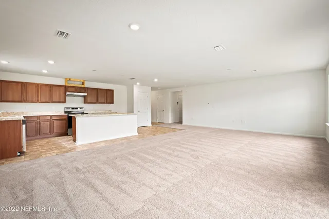 a view of a kitchen with a sink and a stove top oven