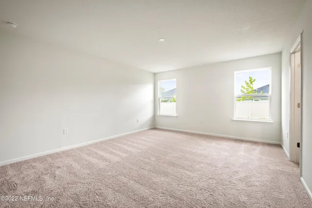 an empty room with windows and outer view