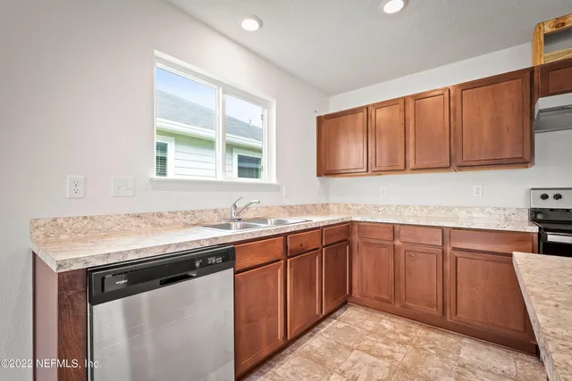 a kitchen with a sink stove and cabinets