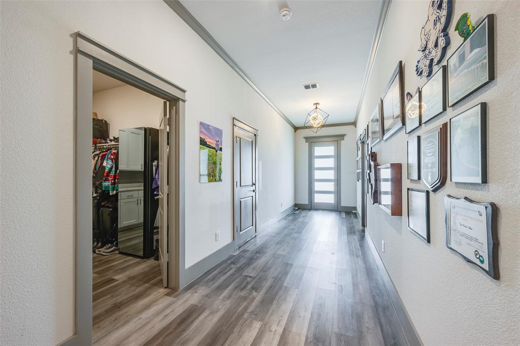 705 Old Agnes Road Weatherford, TX 76088 - Photo 12 of 32 a view of a hallway view with wooden floor and staircase