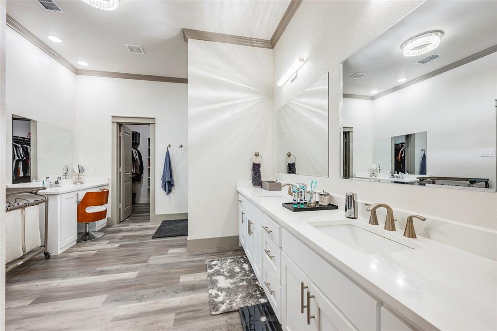 705 Old Agnes Road Weatherford, TX 76088 - Photo 16 of 32 a large bathroom with a double vanity sink a mirror and a bathtub