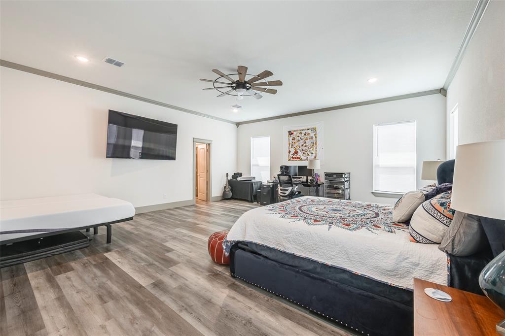 705 Old Agnes Road Weatherford, TX 76088 - Photo 17 of 32 a bedroom with a bed and a flat screen tv