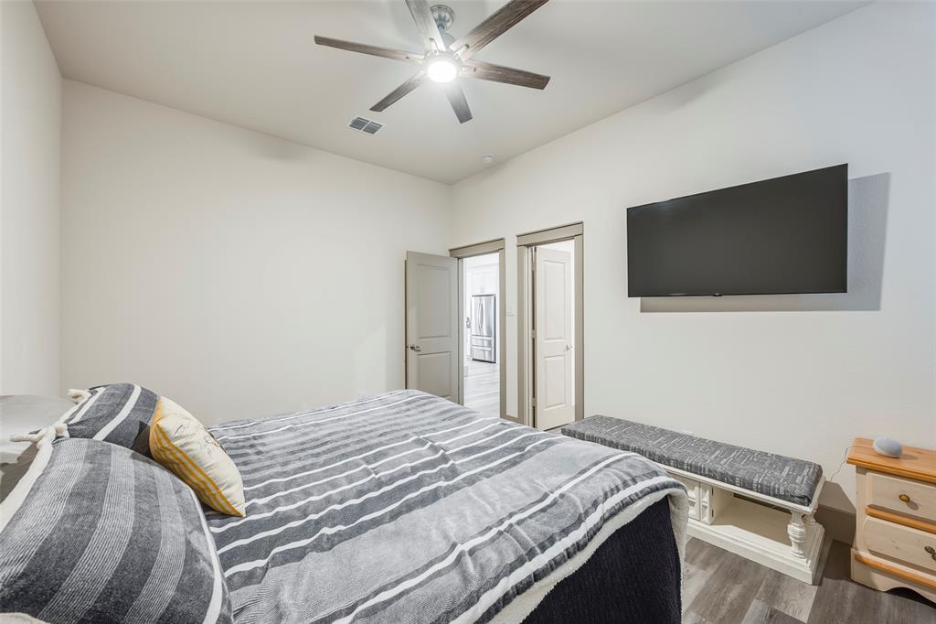 705 Old Agnes Road Weatherford, TX 76088 - Photo 20 of 32 a bedroom with a bed and a flat screen tv