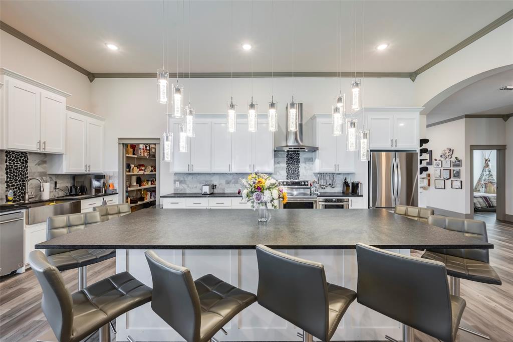 705 Old Agnes Road Weatherford, TX 76088 - Photo 2 of 32 a kitchen with stainless steel appliances granite countertop a stove top oven a sink dishwasher a dining table and chairs