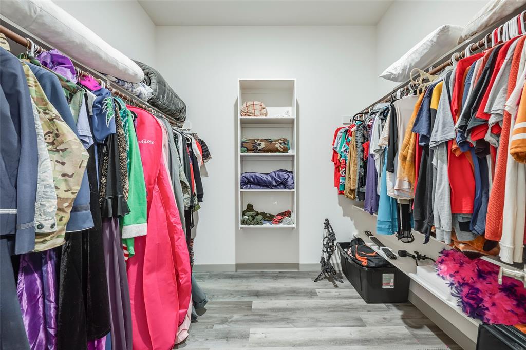 705 Old Agnes Road Weatherford, TX 76088 - Photo 22 of 32 a view of walk in closet with clothes