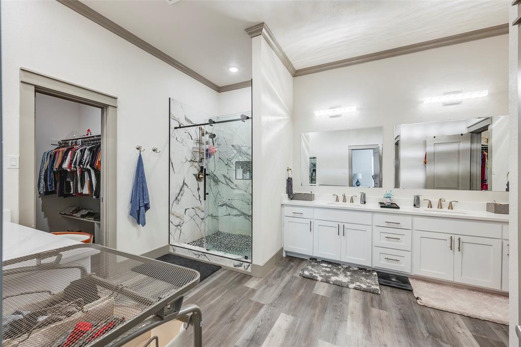 705 Old Agnes Road Weatherford, TX 76088 - Photo 24 of 32 a spacious bathroom with a granite countertop sink a toilet a mirror and shower