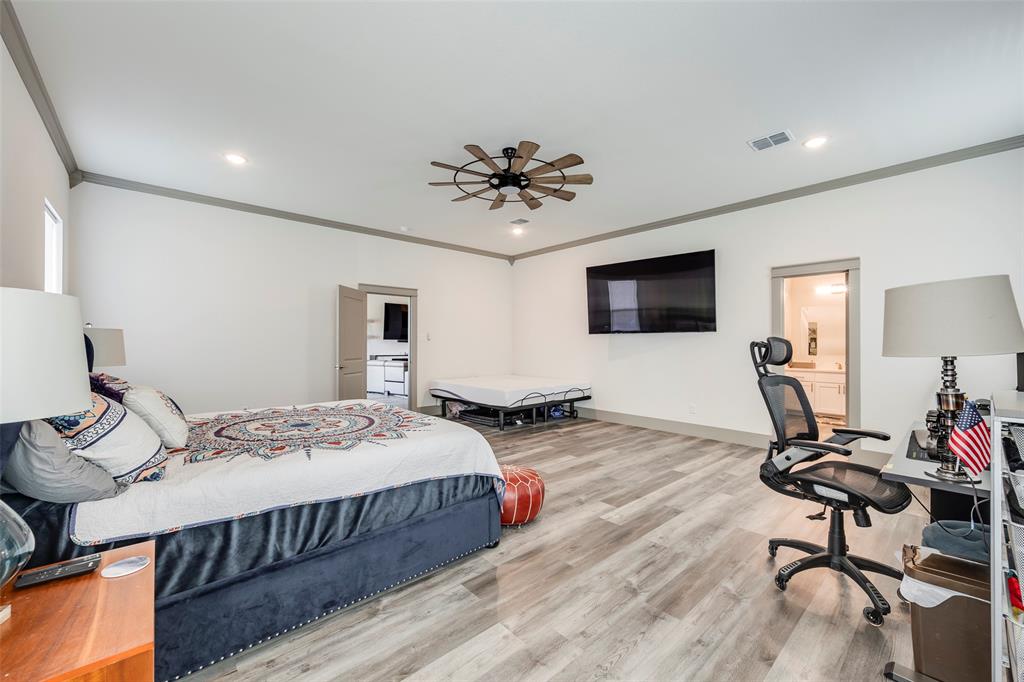 705 Old Agnes Road Weatherford, TX 76088 - Photo 25 of 32 a bedroom with bed a flat tv screen and a dresser