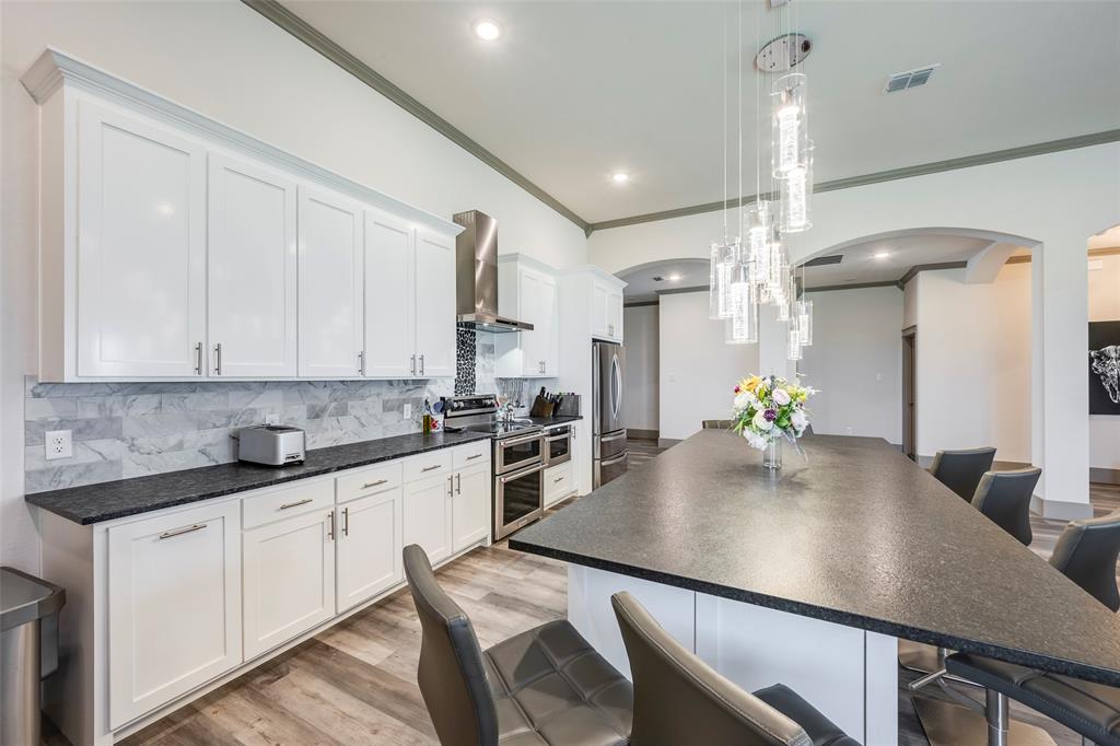 705 Old Agnes Road Weatherford, TX 76088 - Photo 5 of 32 a kitchen with kitchen island a sink appliances and cabinets