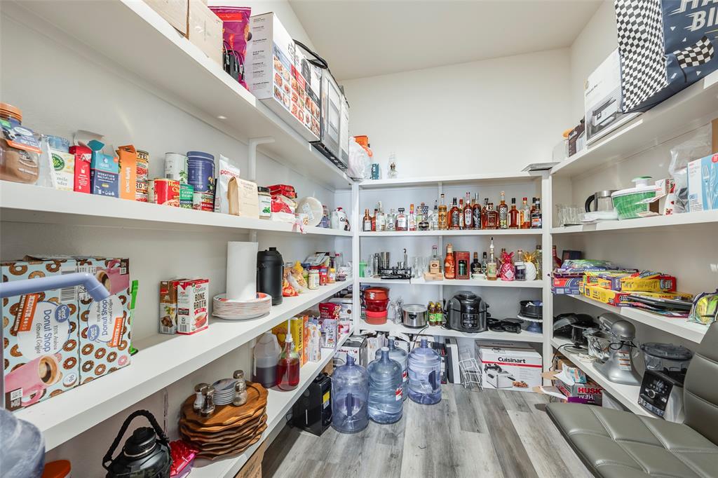 705 Old Agnes Road Weatherford, TX 76088 - Photo 6 of 32 a utility room with lots of clutter and toys