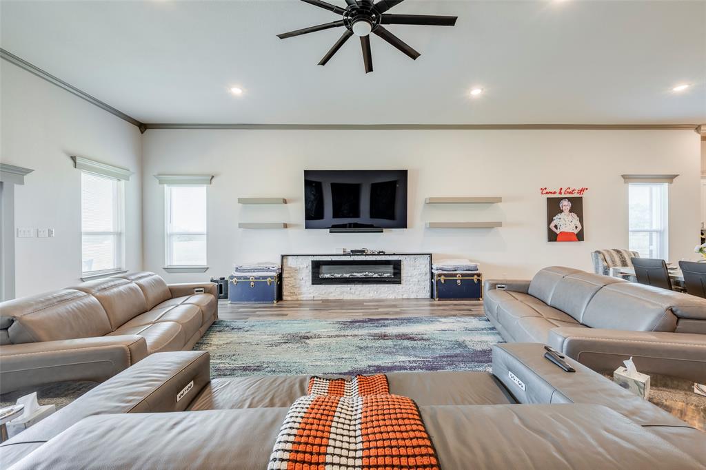 705 Old Agnes Road Weatherford, TX 76088 - Photo 8 of 32 a living room with furniture and a fireplace