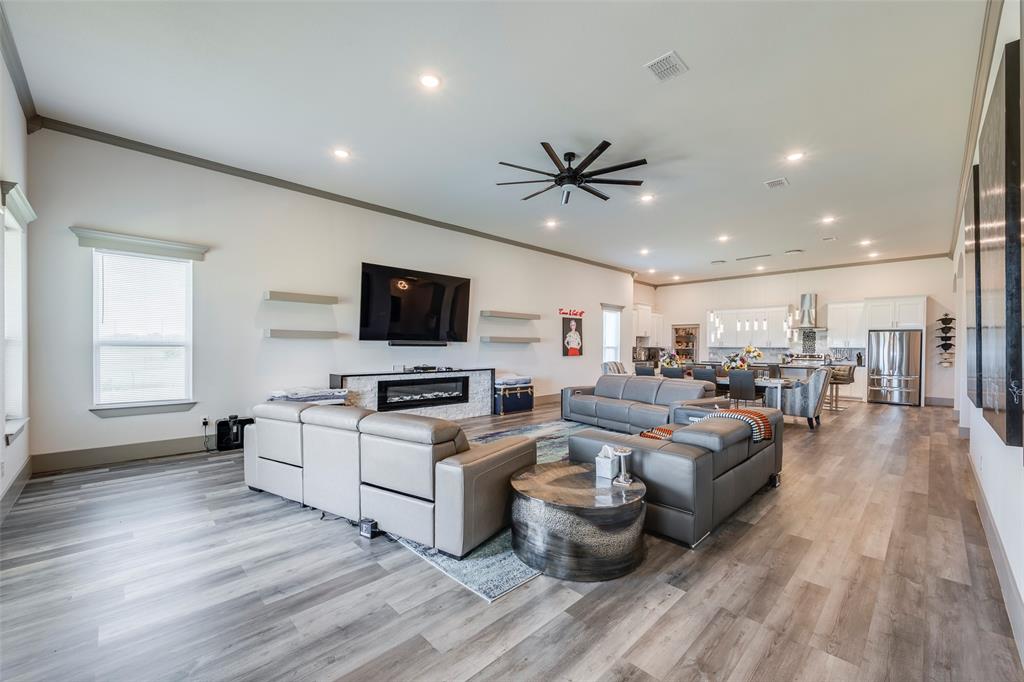 705 Old Agnes Road Weatherford, TX 76088 - Photo 9 of 32 a living room with furniture a flat screen tv and kitchen view