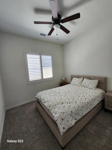 a bedroom with bed and window