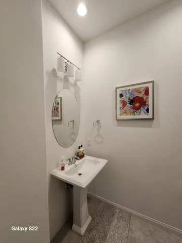 a bathroom with a sink a mirror and a toilet