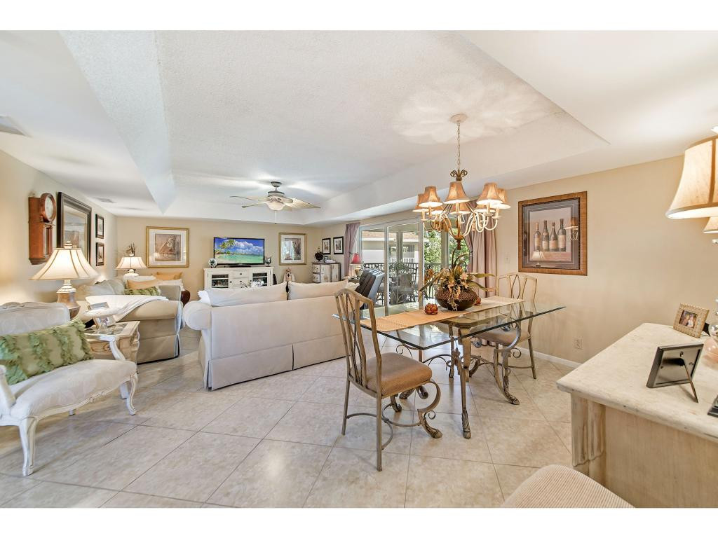740 Teryl Road, Unit 2074 Naples, FL 34112 - Photo 2 of 18 a living room with furniture and a chandelier