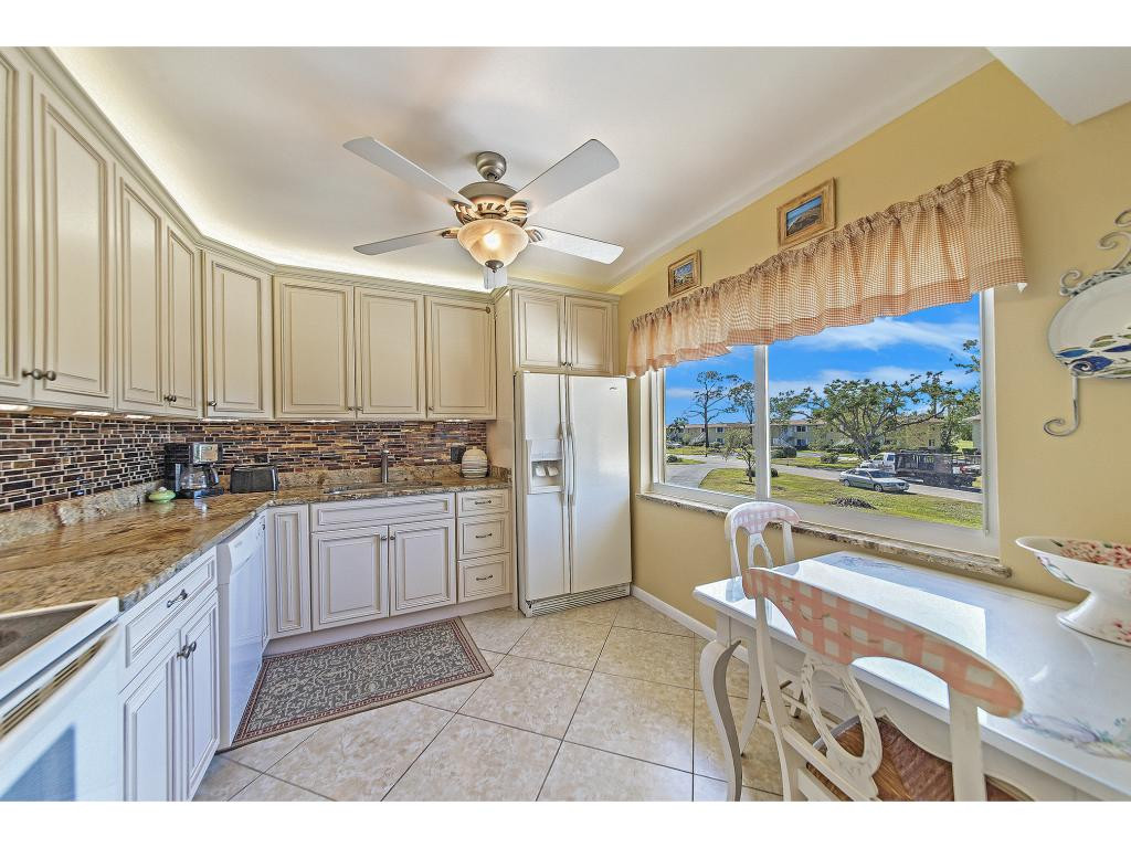 740 Teryl Road, Unit 2074 Naples, FL 34112 - Photo 11 of 18 a kitchen with a refrigerator and a sink
