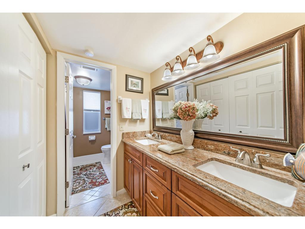 740 Teryl Road, Unit 2074 Naples, FL 34112 - Photo 14 of 18 a bathroom with a sink a mirror and a shower