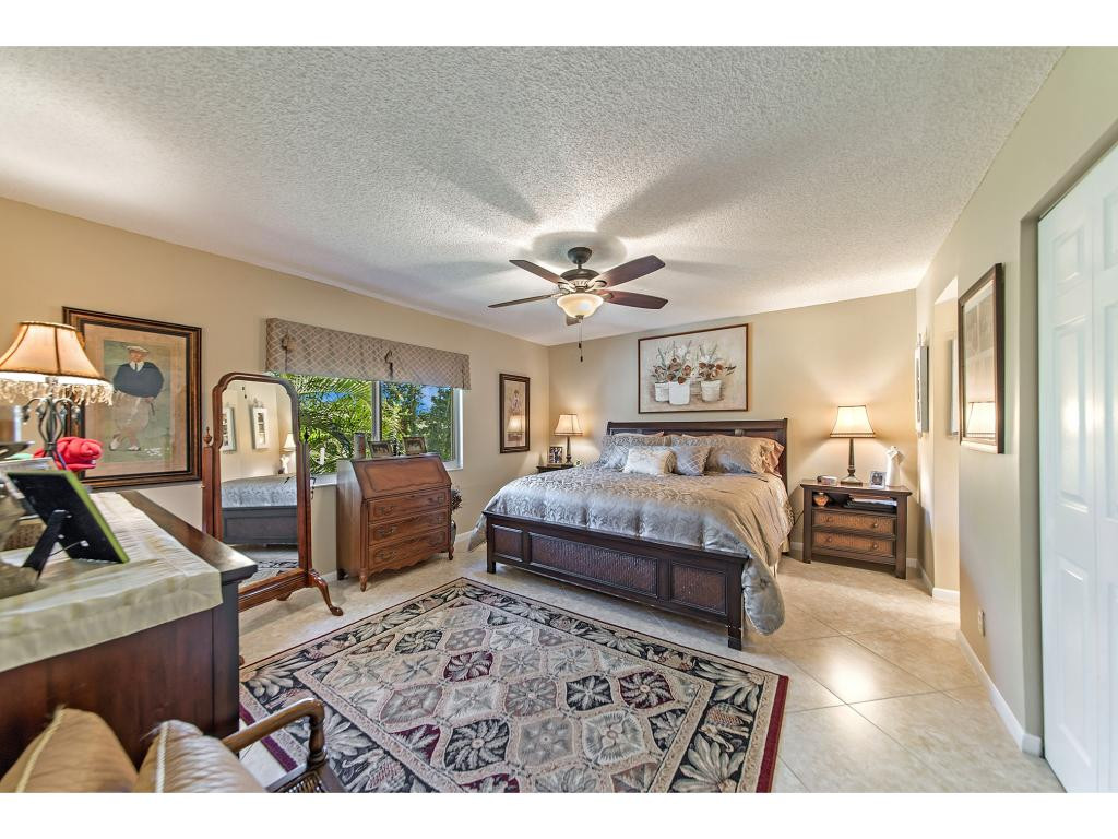 740 Teryl Road, Unit 2074 Naples, FL 34112 - Photo 4 of 18 a bedroom with a large bed and a large window