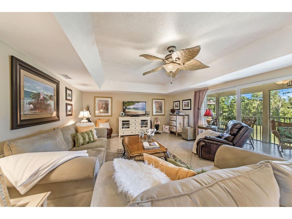 740 Teryl Road, Unit 2074 Naples, FL 34112 - Photo 7 of 18 a living room with furniture large window and flat screen tv
