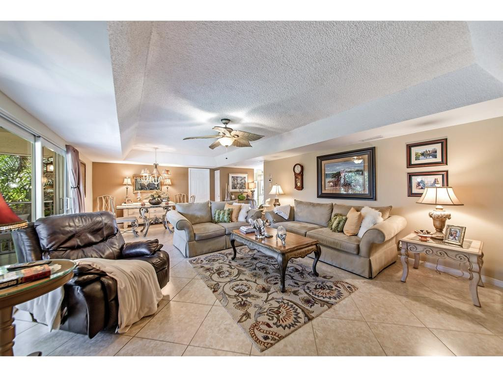 740 Teryl Road, Unit 2074 Naples, FL 34112 - Photo 8 of 18 a living room with lots of furniture and a chandelier