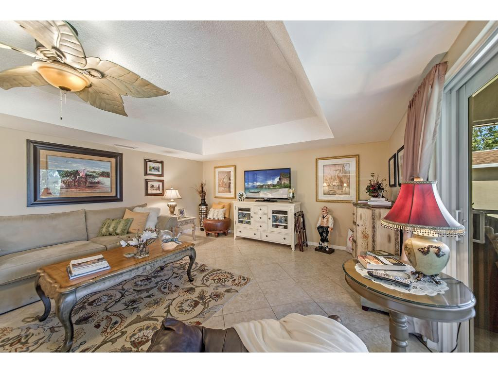 740 Teryl Road, Unit 2074 Naples, FL 34112 - Photo 9 of 18 a living room with furniture and a flat screen tv