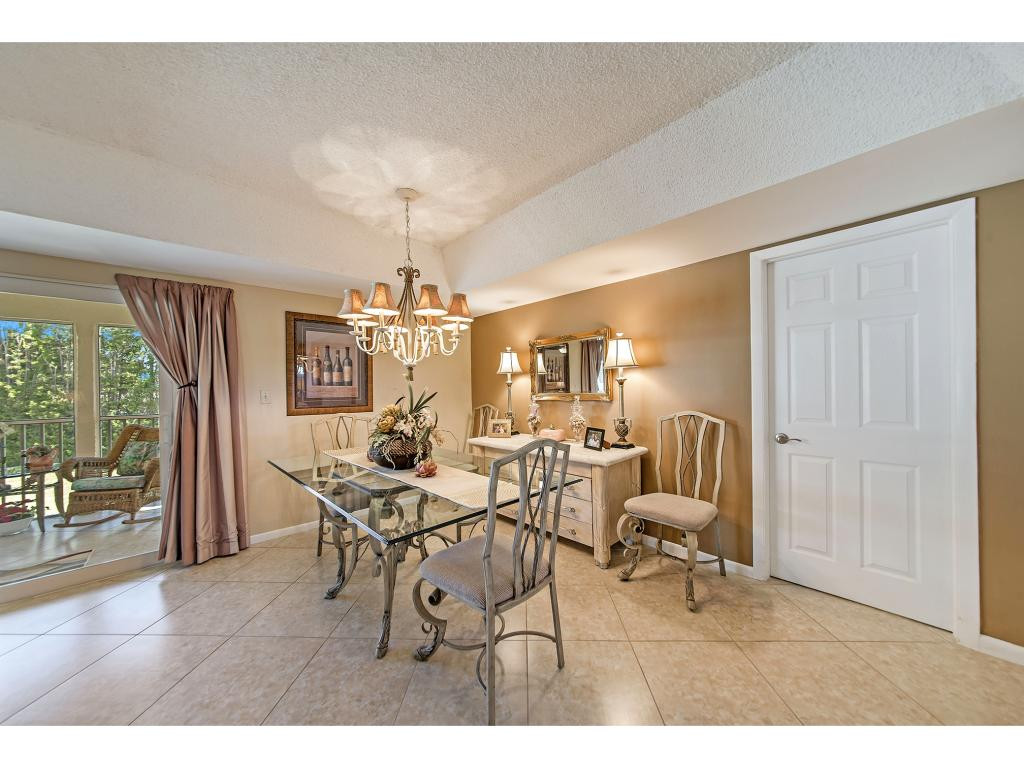 740 Teryl Road, Unit 2074 Naples, FL 34112 - Photo 10 of 18 a view of a dining room with furniture and a chandelier