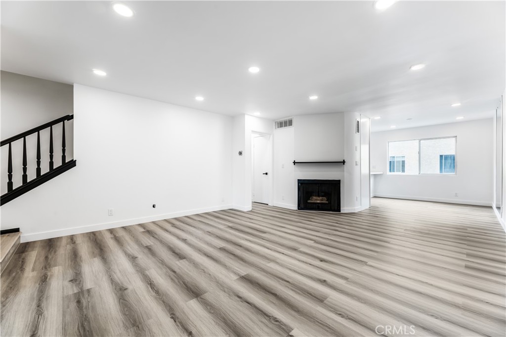 7953 Vía Latina Burbank, CA 91504 - Photo 19 of 30 a view of empty room with wooden floor and fireplace
