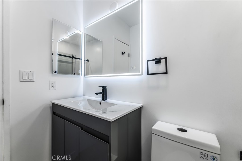 7953 Vía Latina Burbank, CA 91504 - Photo 20 of 30 a bathroom with a sink a toilet and mirror