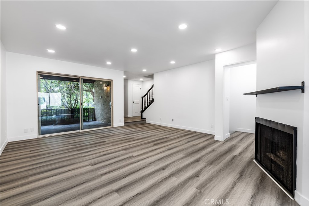 7953 Vía Latina Burbank, CA 91504 - Photo 2 of 30 a view of empty room with wooden floor and fireplace