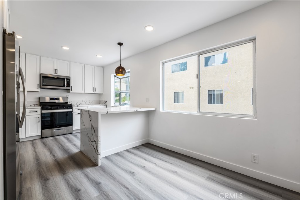 7953 Vía Latina Burbank, CA 91504 - Photo 5 of 30 a kitchen with stainless steel appliances a refrigerator and a stove top oven