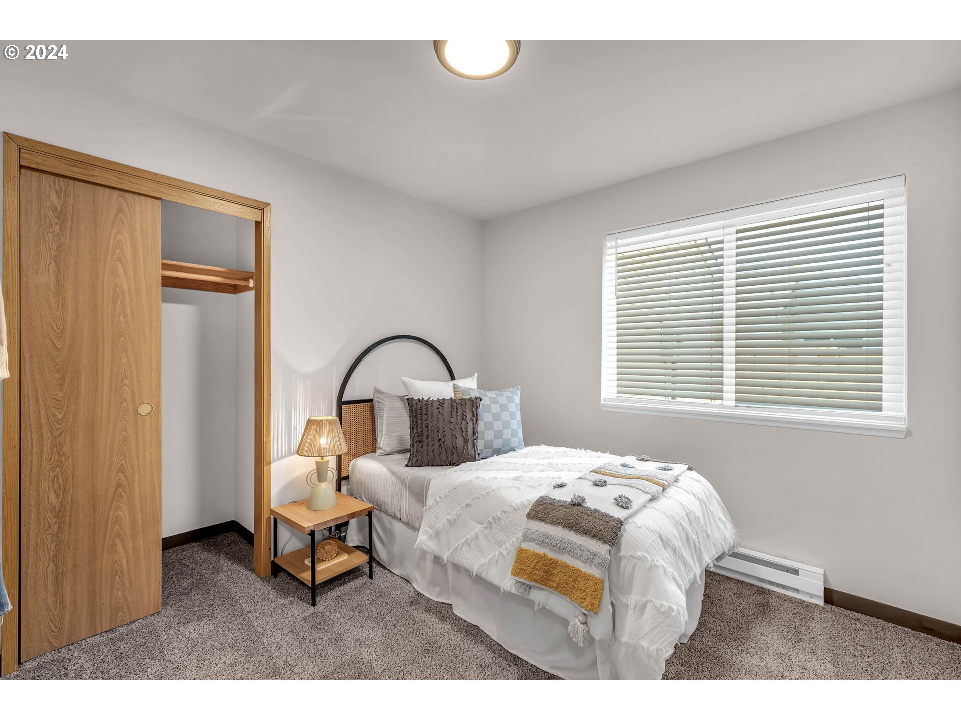 902 Pioneer Street, Unit 910 Ridgefield, WA 98642 - Photo 18 of 31 a bedroom with a bed and a large window