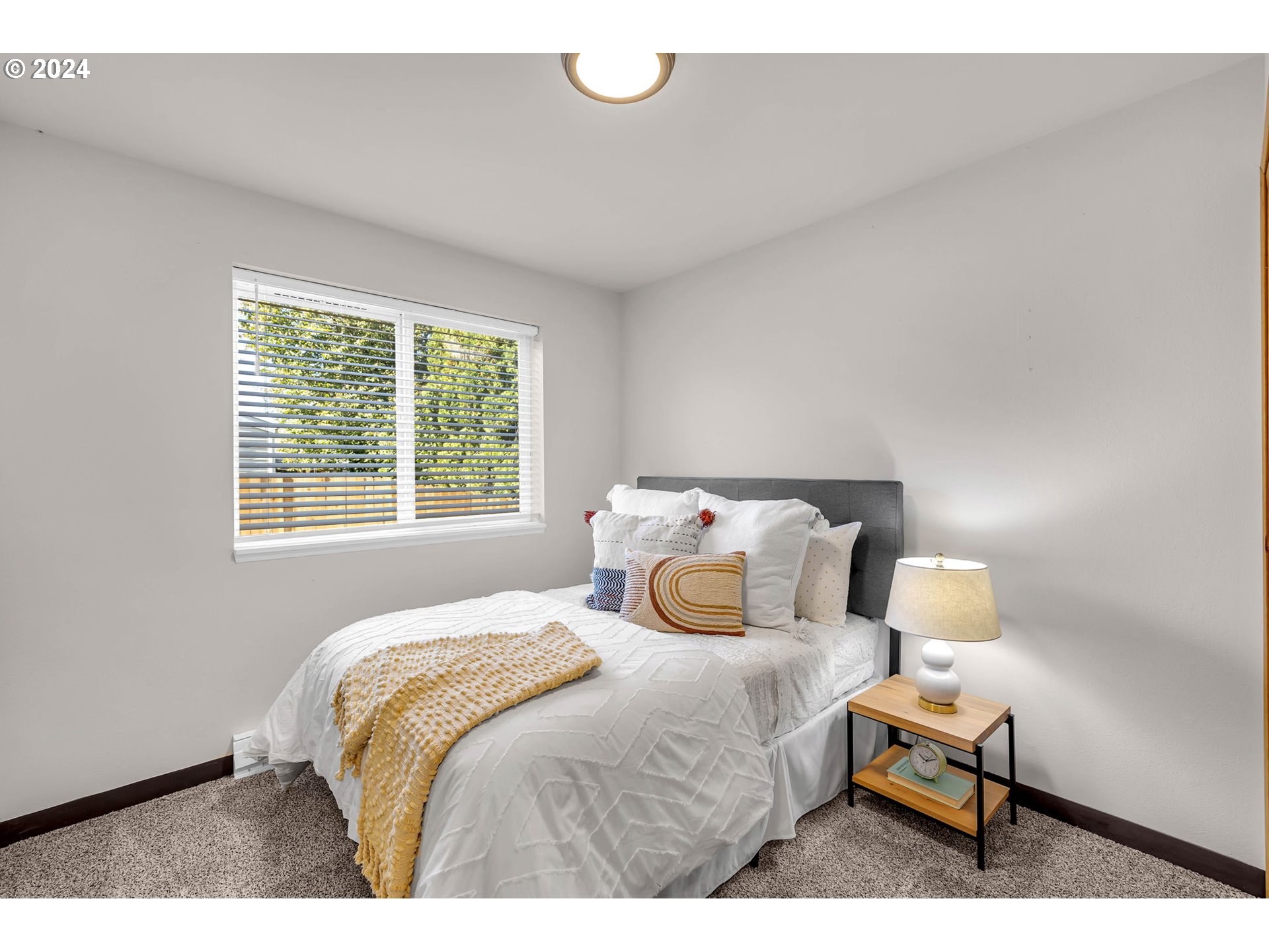 902 Pioneer Street, Unit 910 Ridgefield, WA 98642 - Photo 19 of 31 a bedroom with a bed and window