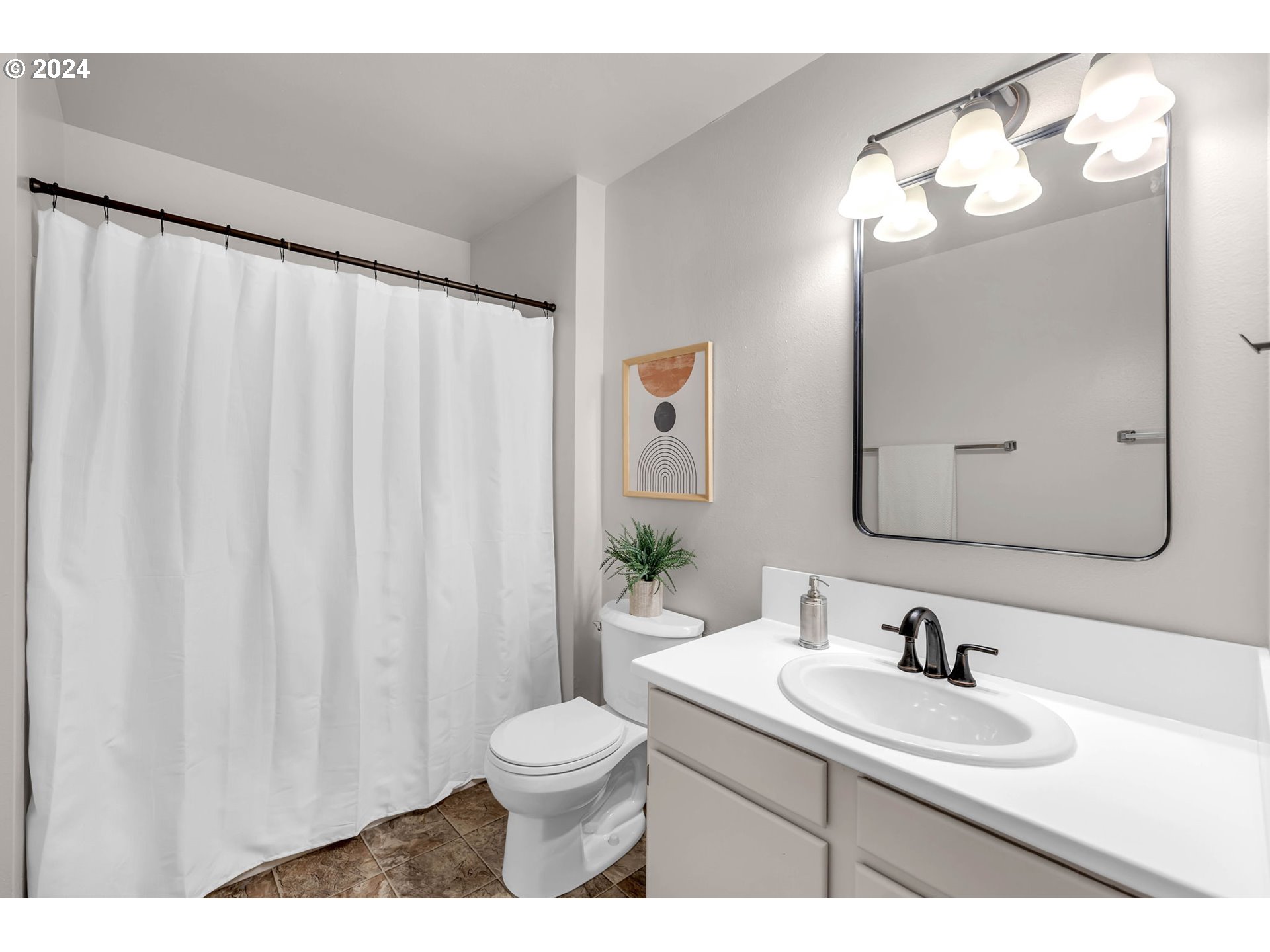 902 Pioneer Street, Unit 910 Ridgefield, WA 98642 - Photo 21 of 31 a bathroom with a sink a toilet and a mirror