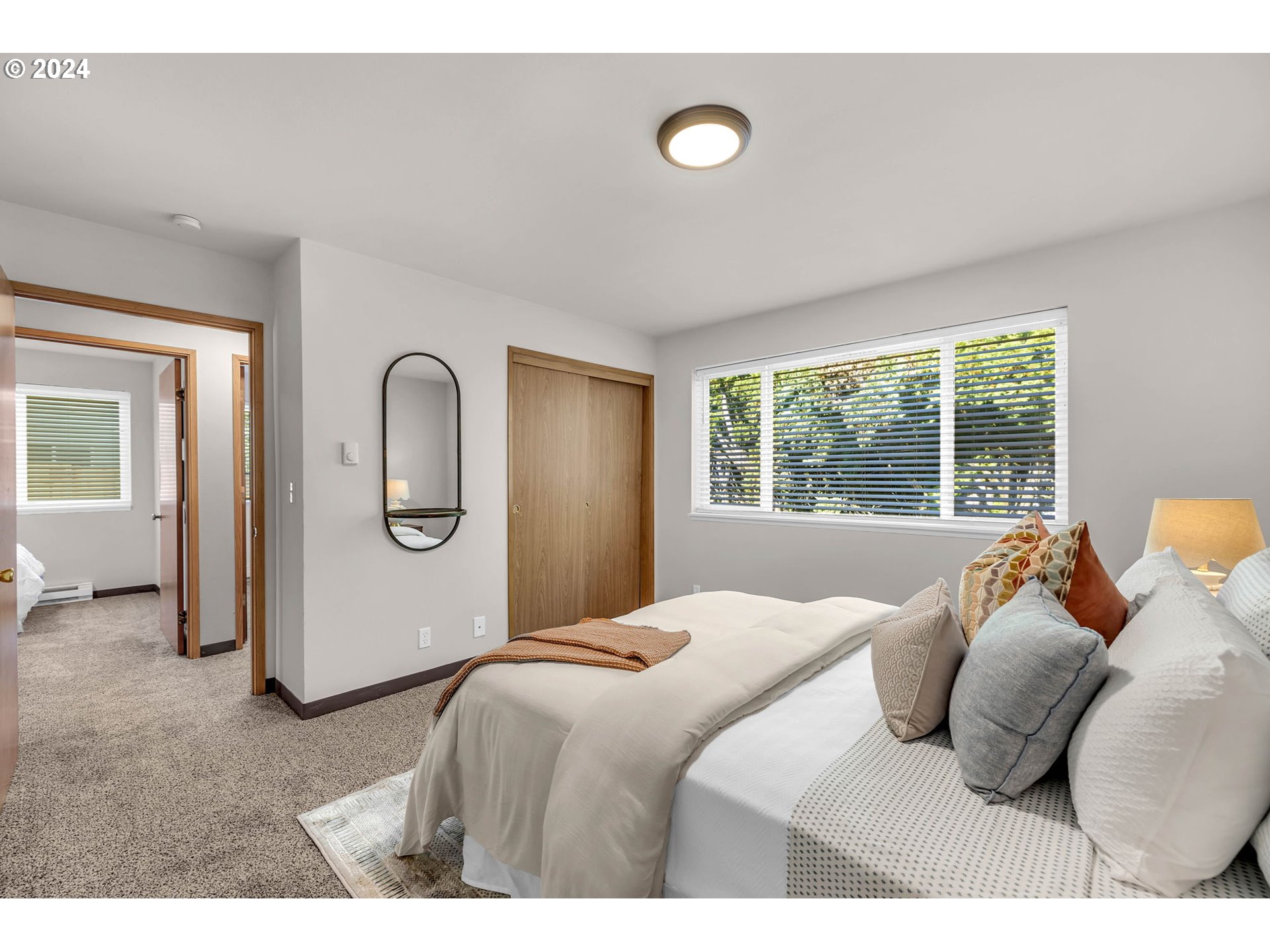 902 Pioneer Street, Unit 910 Ridgefield, WA 98642 - Photo 23 of 31 a bedroom with a bed and a large window