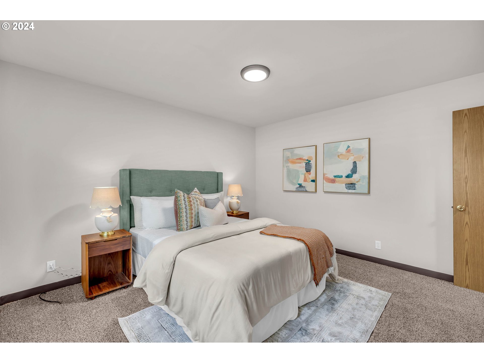 902 Pioneer Street, Unit 910 Ridgefield, WA 98642 - Photo 24 of 31 a bedroom with a bed and a night stand