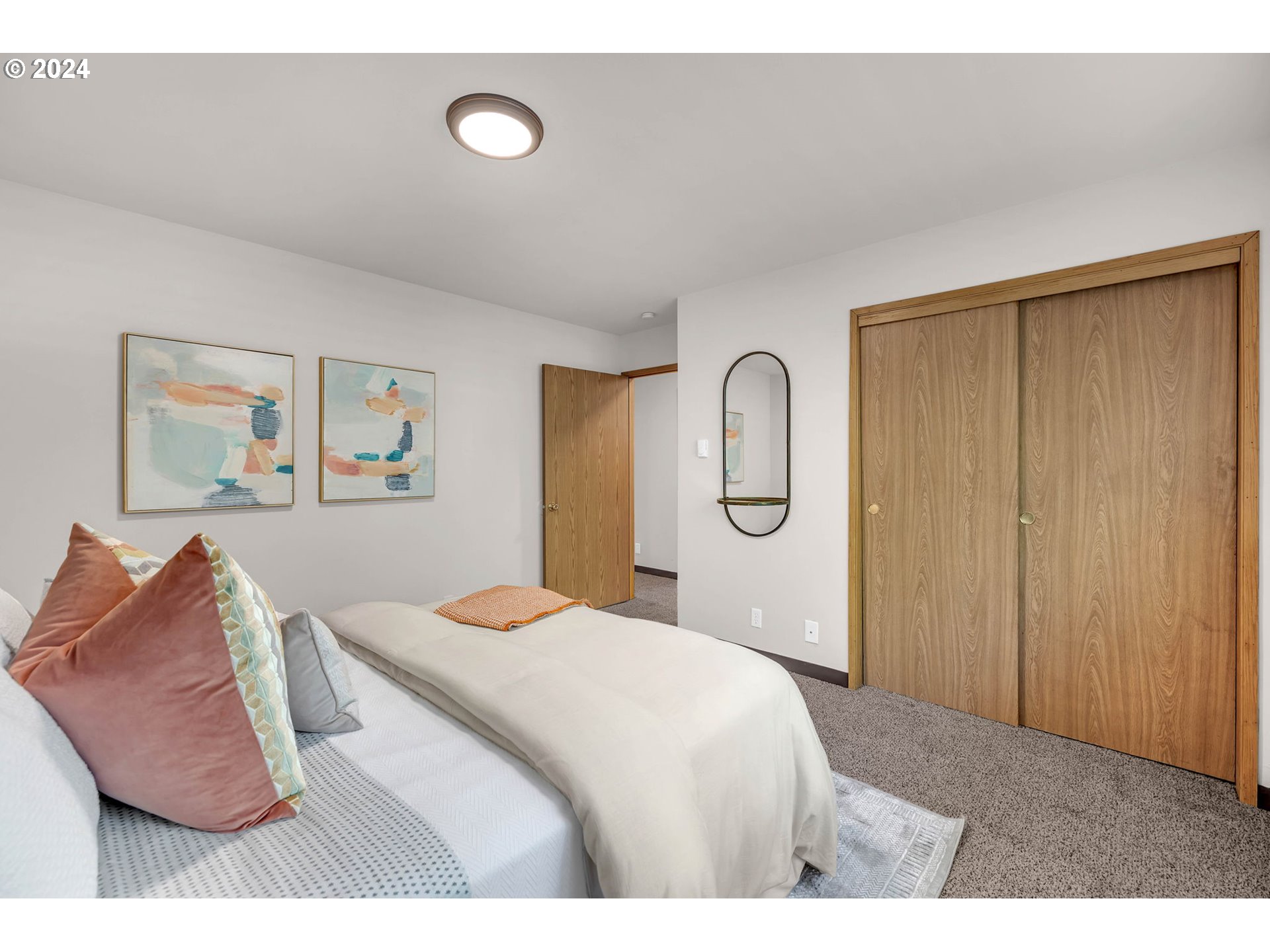 902 Pioneer Street, Unit 910 Ridgefield, WA 98642 - Photo 25 of 31 a bedroom with a bed and wall painting