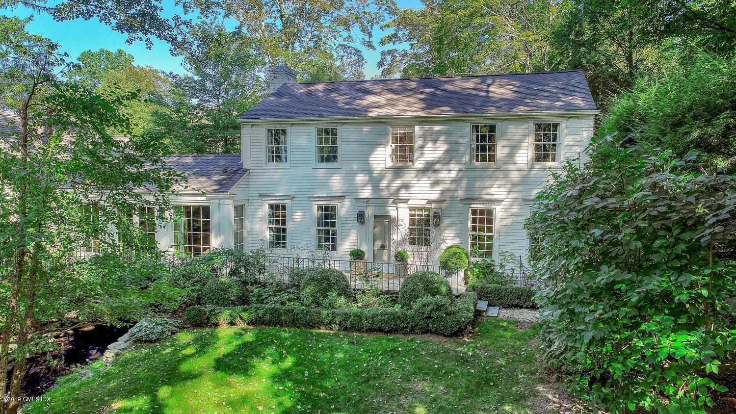 166 Old Church Road Greenwich, CT 06830 - Photo 1 of 20 a front view of a house with a yard and trees