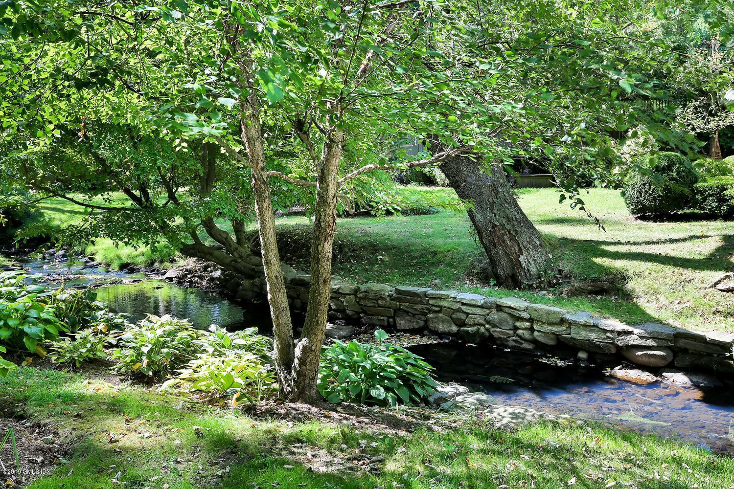 166 Old Church Road Greenwich, CT 06830 - Photo 16 of 20 a view of a garden with a tree
