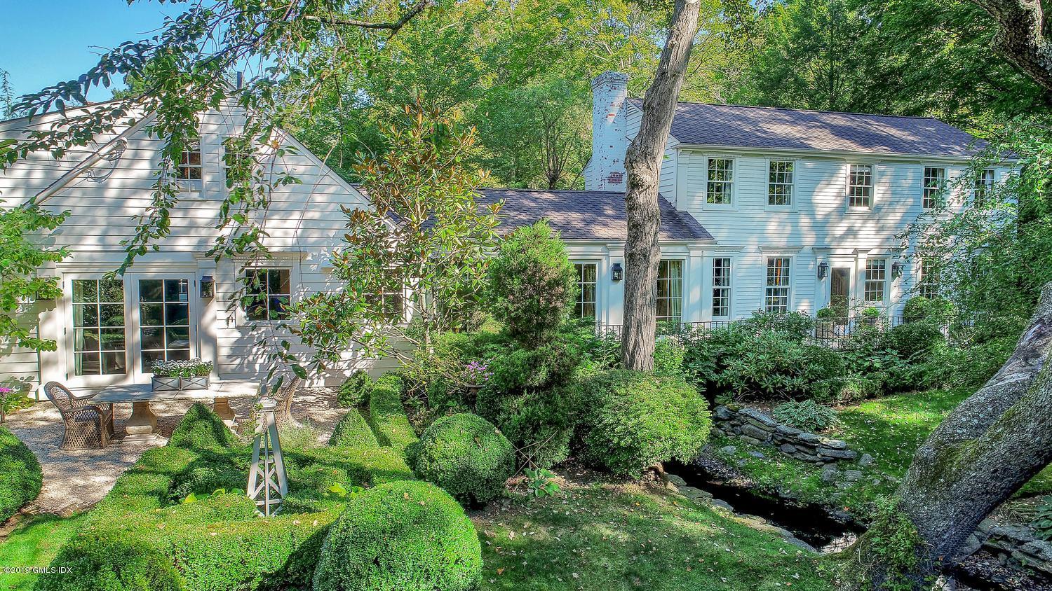 166 Old Church Road Greenwich, CT 06830 - Photo 2 of 20 a view of a house with a yard and potted plants