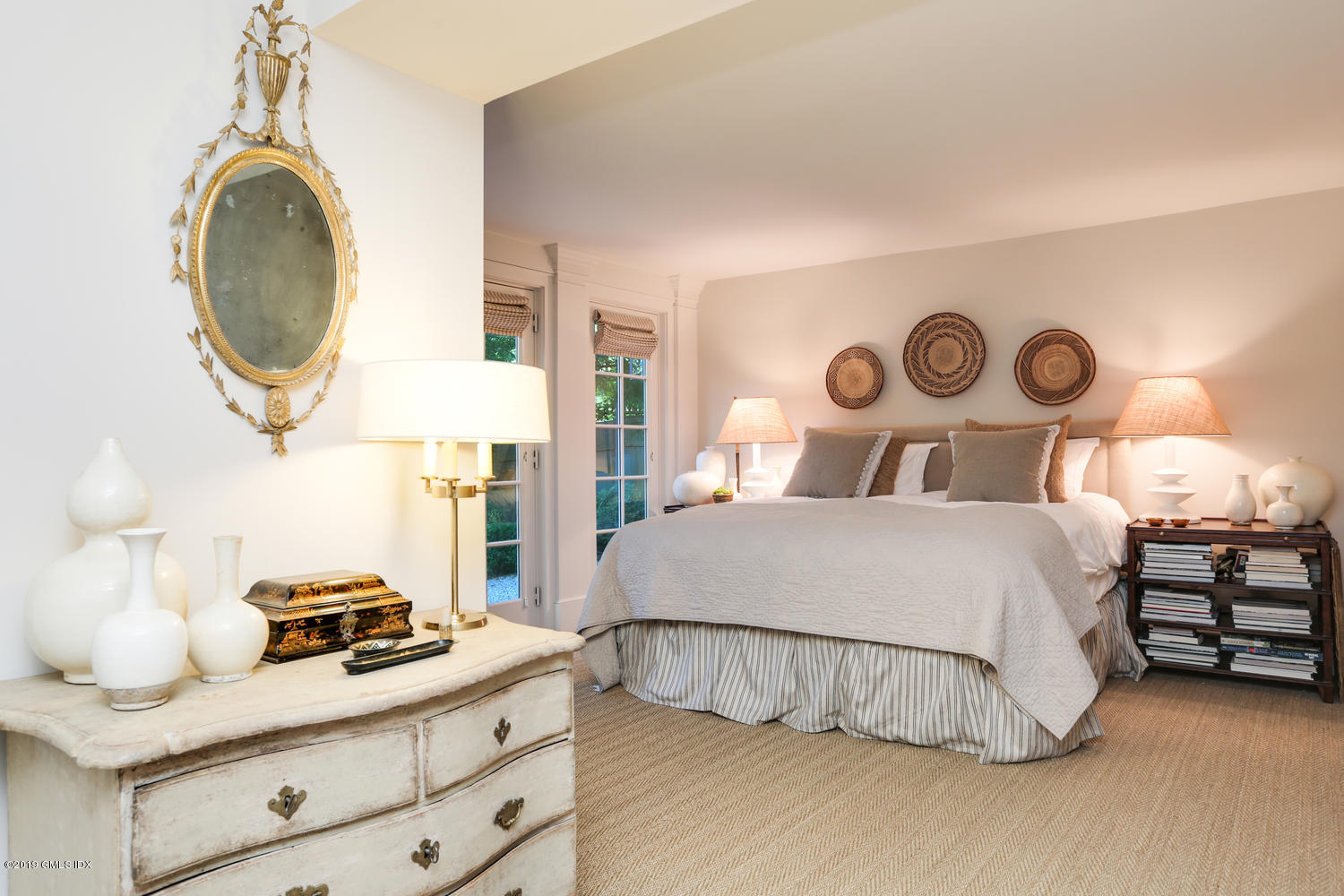 166 Old Church Road Greenwich, CT 06830 - Photo 10 of 20 a bedroom with a bed and a chandelier