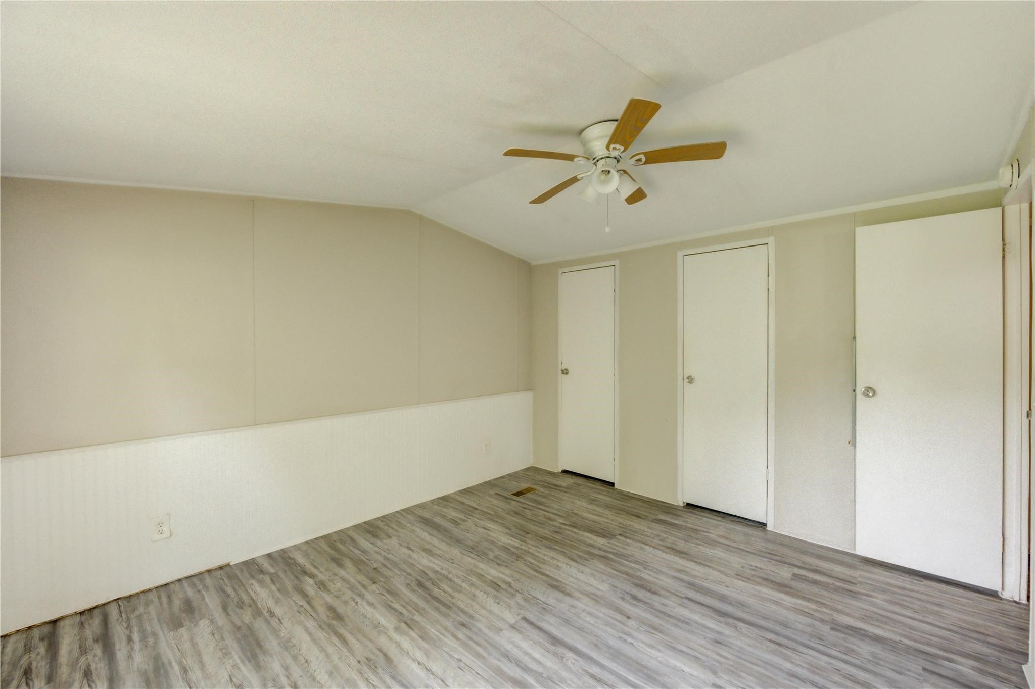 13265 Pecan Tree Drive Willis, TX 77318 - Photo 13 of 19 a view of a room with wooden floor and ceiling fan