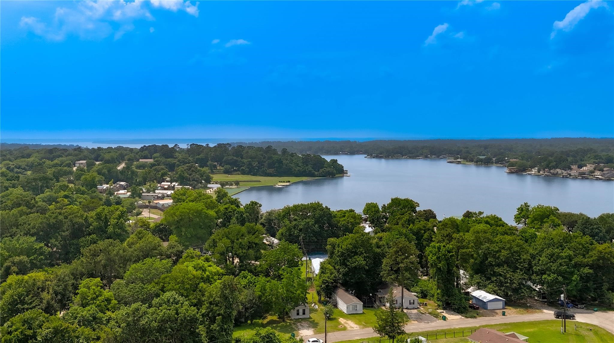 13265 Pecan Tree Drive Willis, TX 77318 - Photo 18 of 19 a view of a lake with houses in the back