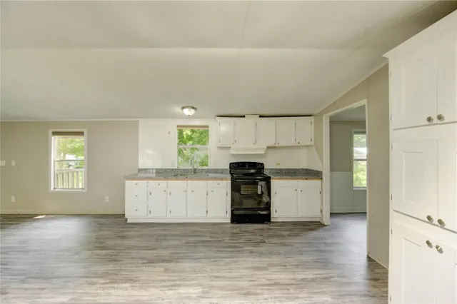 a kitchen with a refrigerator and a stove top oven
