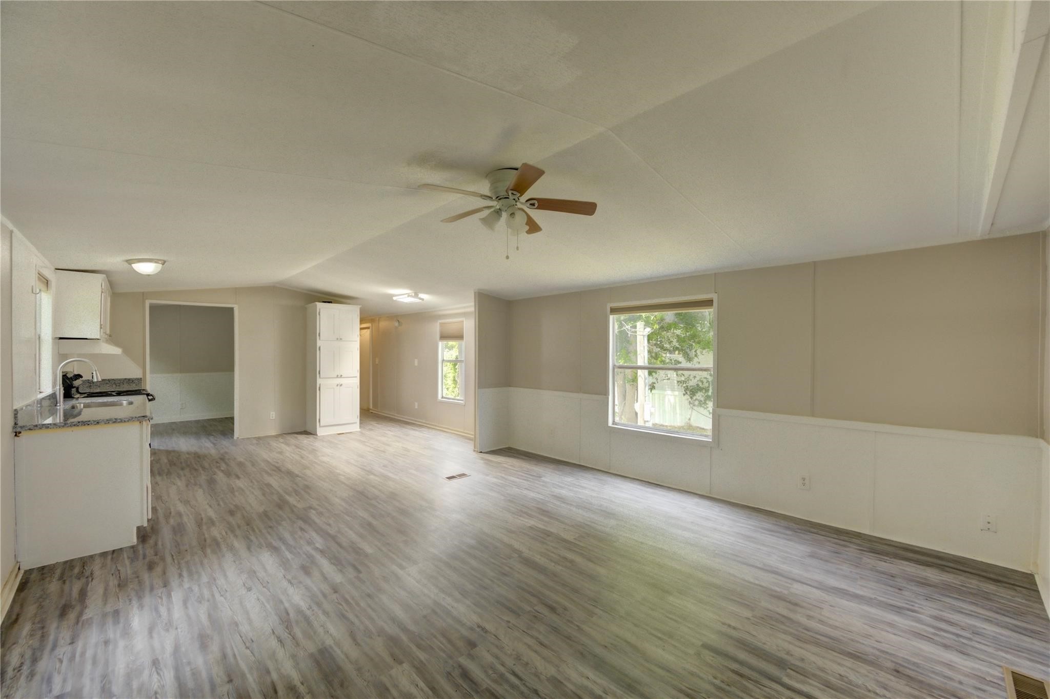 13265 Pecan Tree Drive Willis, TX 77318 - Photo 7 of 19 a view of an empty room with a kitchen and a window
