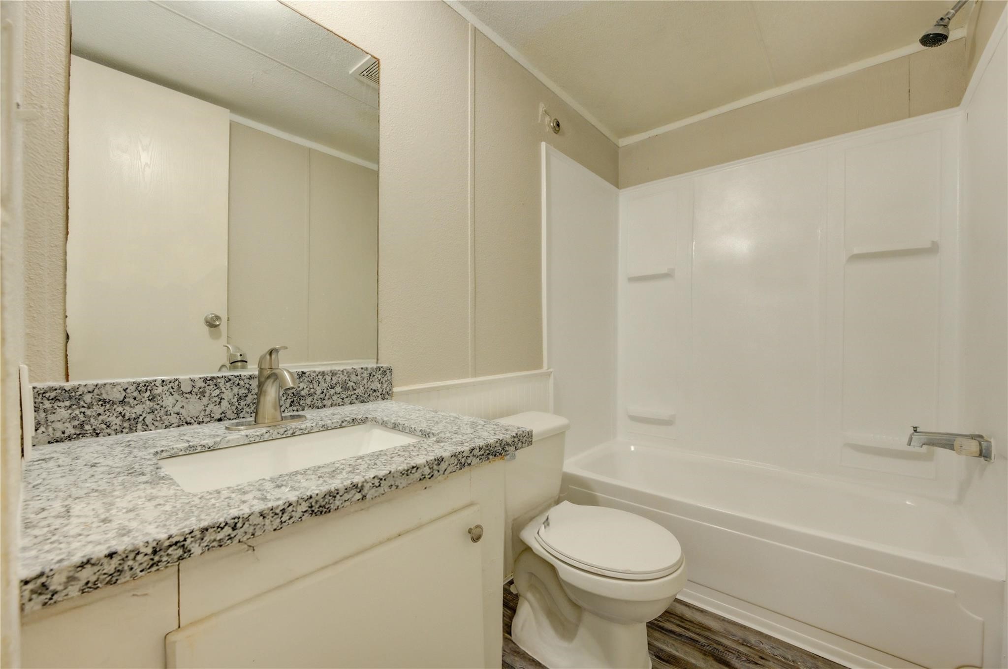 13265 Pecan Tree Drive Willis, TX 77318 - Photo 8 of 19 a bathroom with a granite countertop sink toilet and shower
