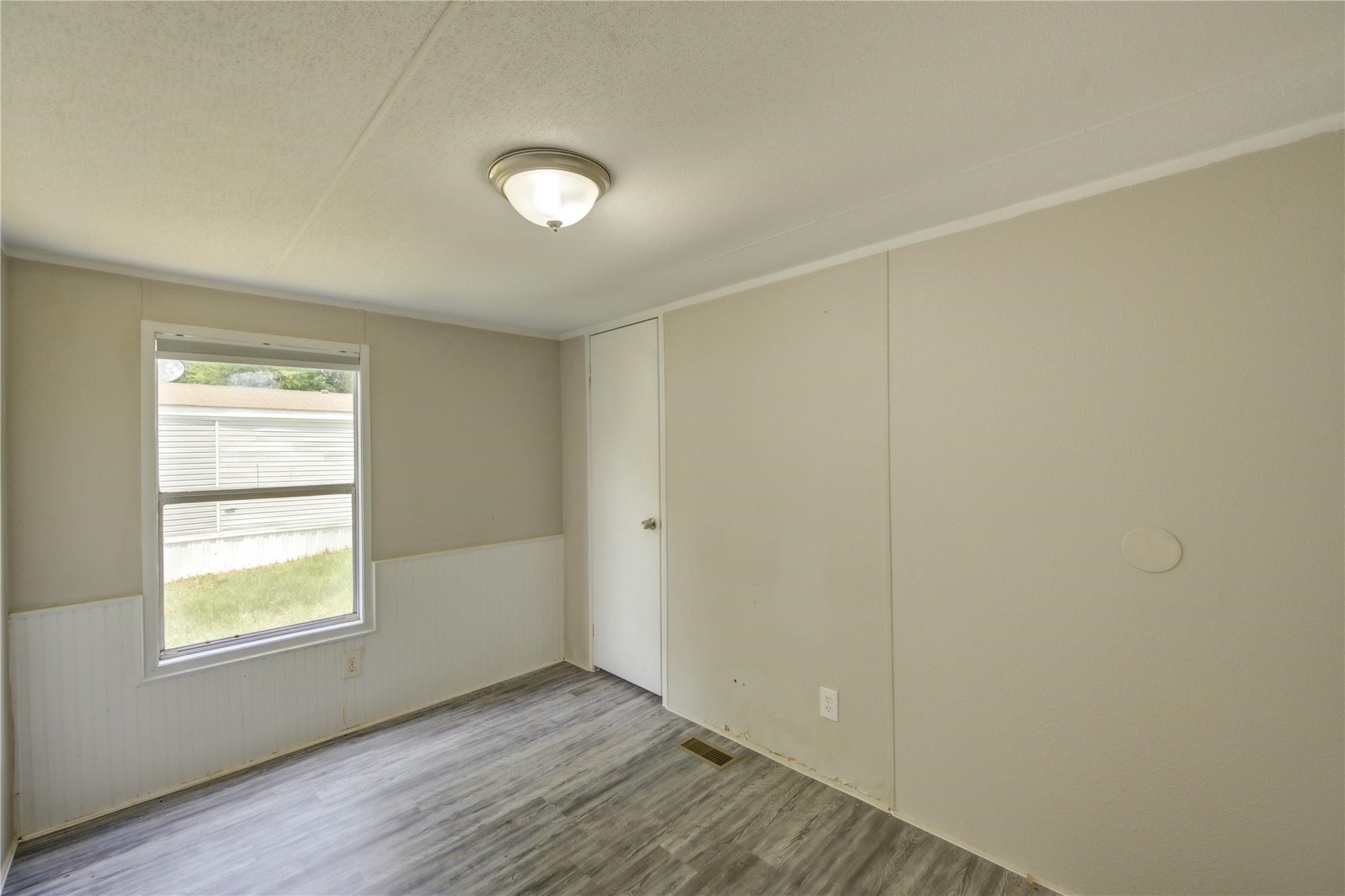 13265 Pecan Tree Drive Willis, TX 77318 - Photo 9 of 19 an empty room with wooden floor and windows