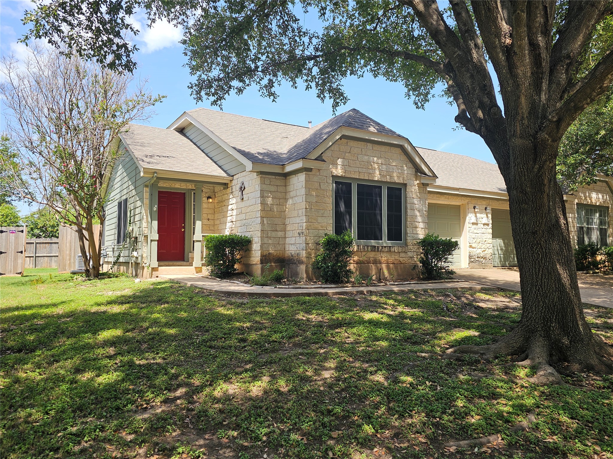 174 Prairie Springs Loop Georgetown, TX 78626 - Photo 1 of 1 A classic facade of light-toned stone and siding offers a welcoming curb appeal with a prominent red front door.