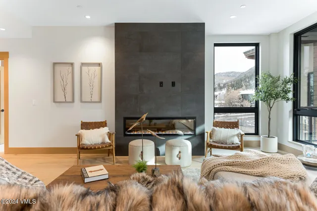 a bedroom with a bed and large windows